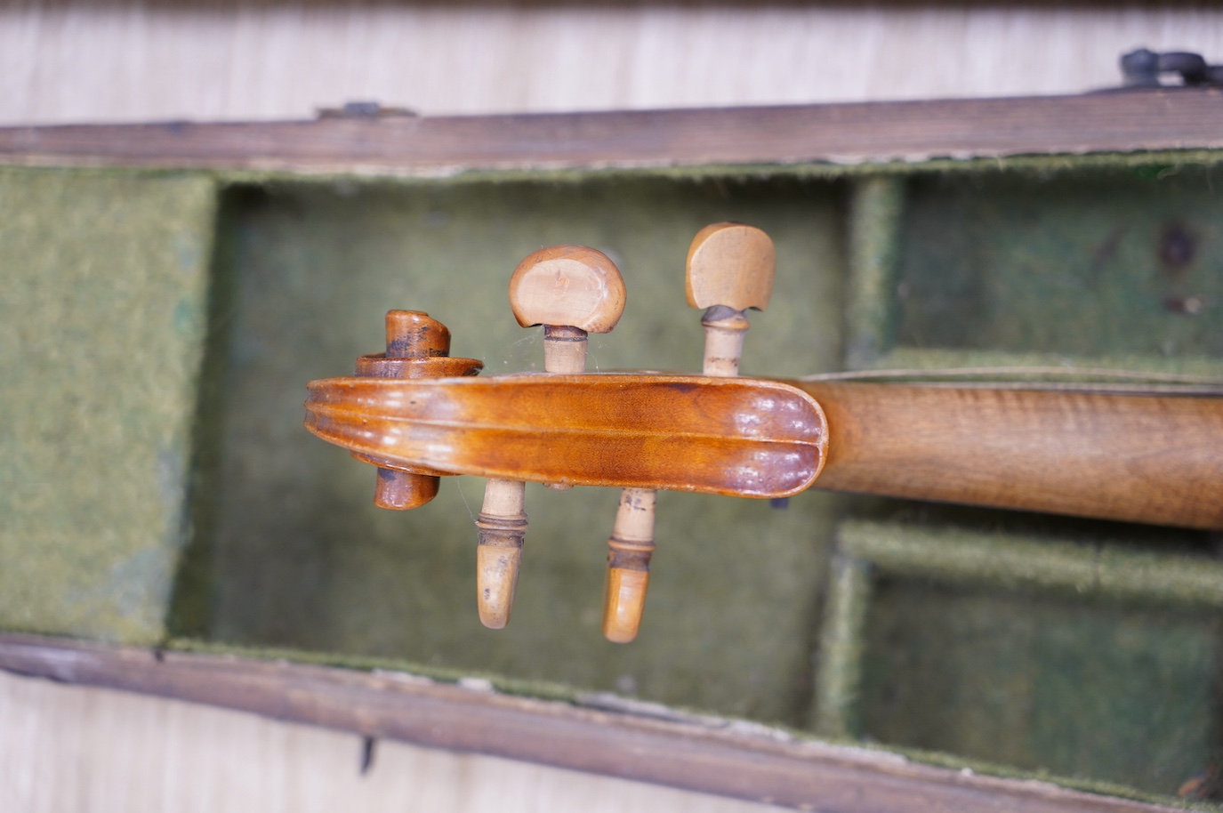 A late 19th century German violin, bearing a Stradivarius label, dated 1717, with mother of pearl inlaid tailpiece, in a walnut case and with bow, the bow stamped Vuillaume & Paris. Condition - fair